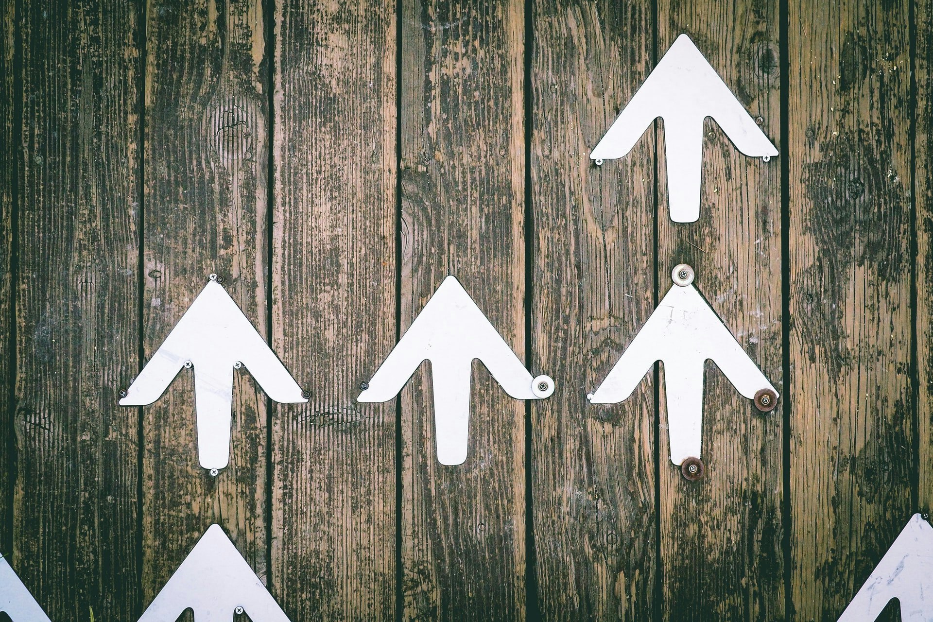 Up arrows on the wood background